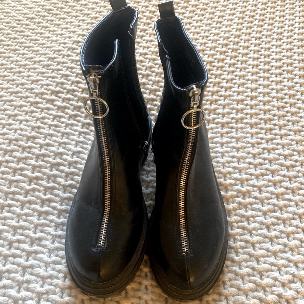 Chunky booties with decorative zipper front.